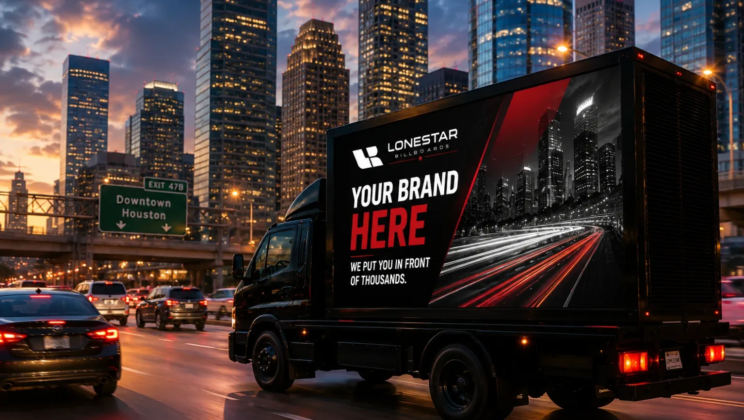 LED billboard truck with bright digital display driving through a busy city intersection